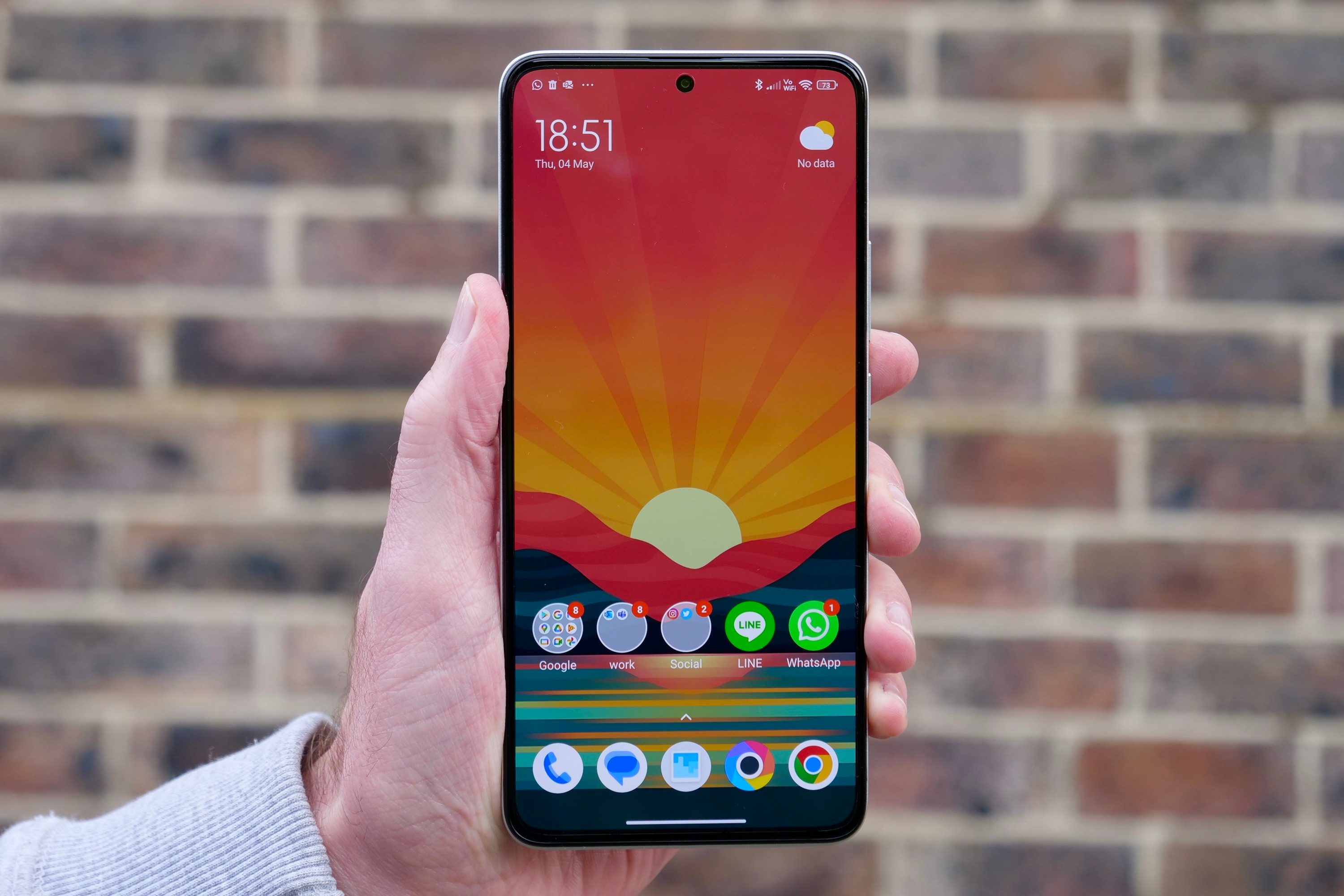 A person holding the Poco F5 Pro showing the screen.