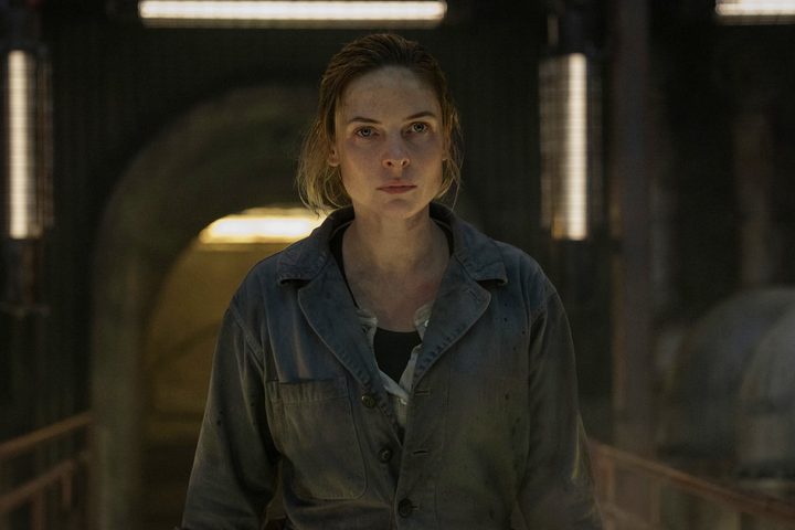 Rebecca Ferguson stands on a catwalk in Silo.