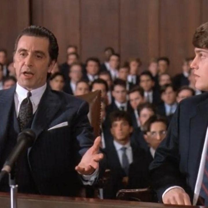 A blind man sits next to a teenager at a table in Scent of a Woman.