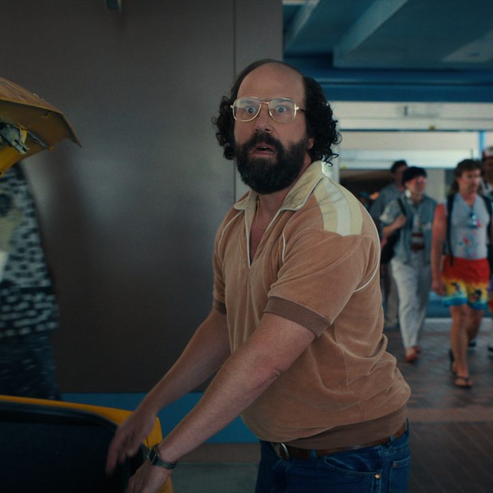 Brett Gelman stands next to the trunk of car in Stranger Things.
