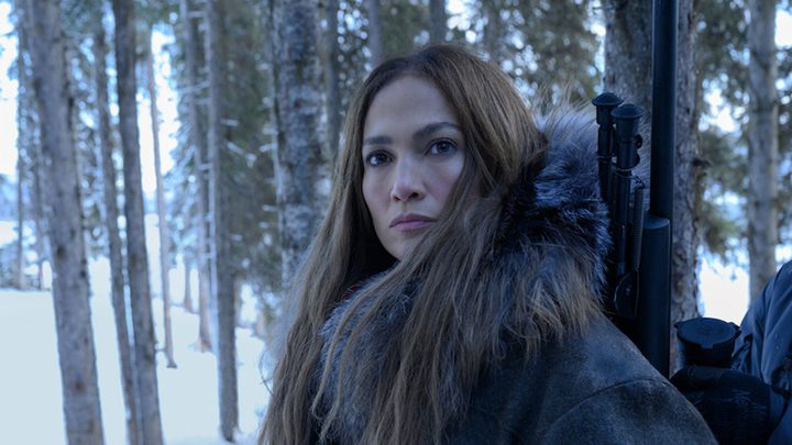 Jennifer Lopez as The Mother standing in a snowy forest looking to her left in The Mother.