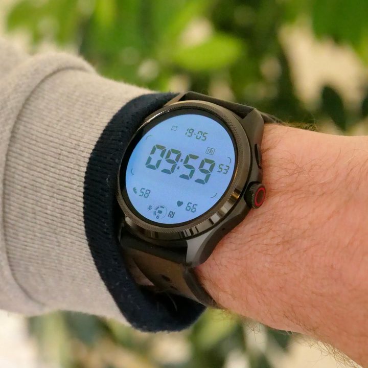 The Mobvoi TicWatch Pro 5 on a person's wrist, showing the backlit secondary screen.