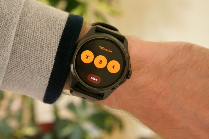 The Mobvoi TicWatch Pro 5 on a person's wrist, showing the basic workout menu.