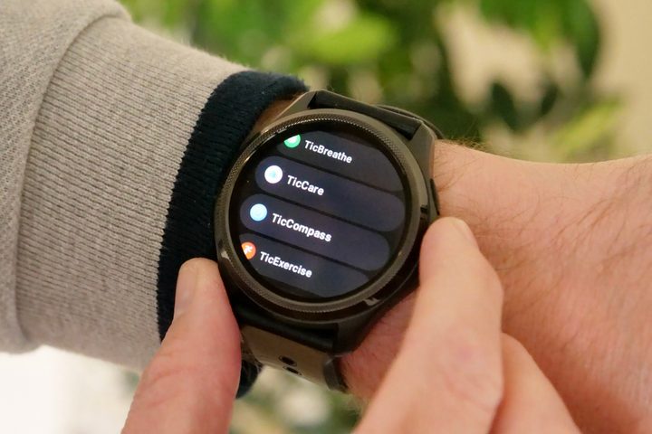 The Mobvoi TicWatch Pro 5 on a person's wrist, showing the menu.
