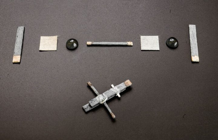 The components of a wooden transistor laid out on a table.
