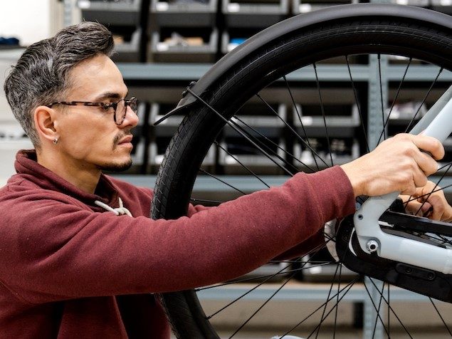 Upway technician inspecting ebike before listing on marketplace.