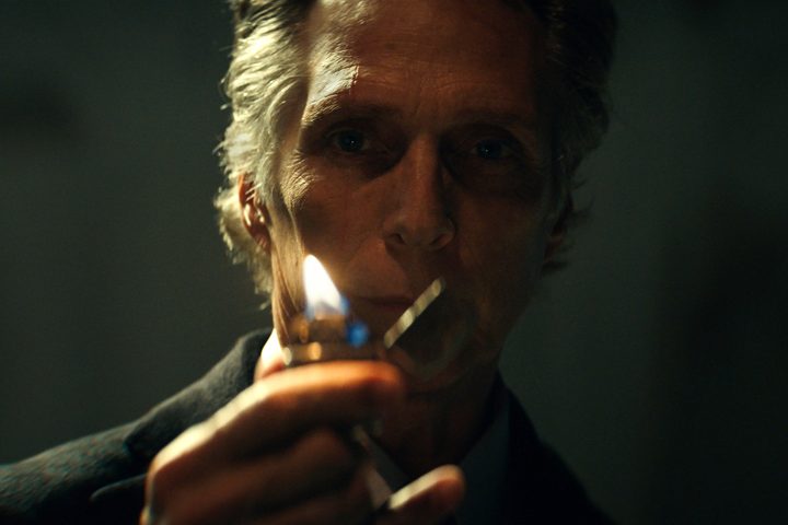 William Fichtner holds up a lighter in Hypnotic.