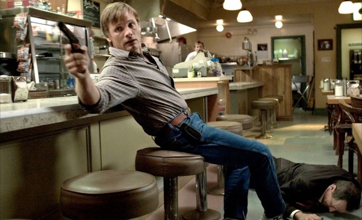 A man holds a gun in A History of Violence.