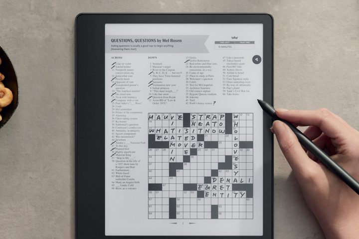 Someone doing a crossword on the Amazon Kindle Scribe.