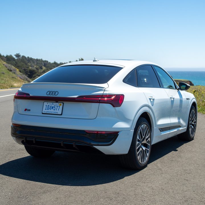 Audi Q8 e-tron sportback in white, parked on a road.