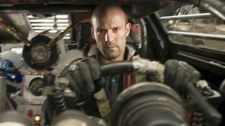 Jason Statham sits behind the wheel of a car in Death Race.