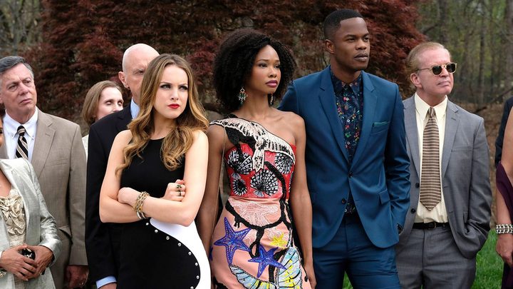 Characters from Dynasty dressed to the nines, standing and looking at something.