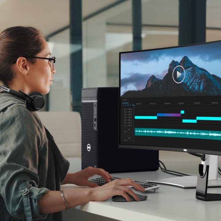 A woman using a 38-inch ultrawide Dell monitor.