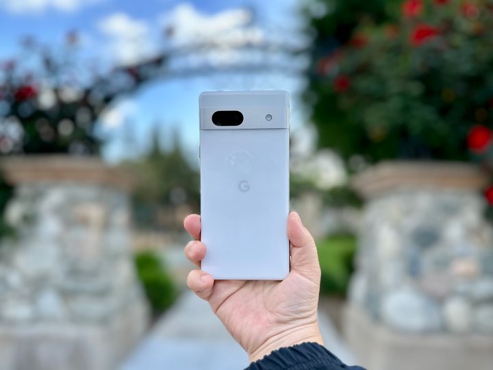 Google Pixel 7a in Snow held in hand