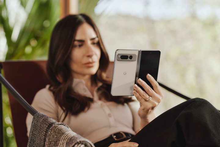 Google Pixel Fold opened being held in woman's hand