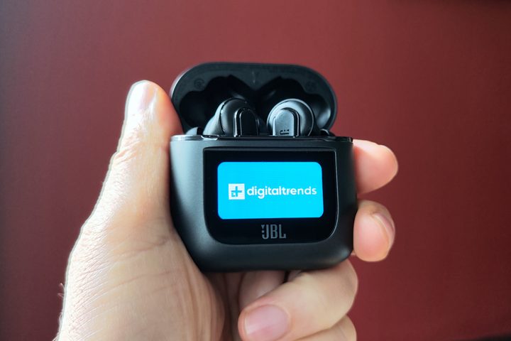 JBL Tour Pro 2 held in hand, displaying the Digital Trends logo on the case touchscreen.