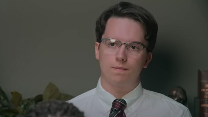 Noah from Jury Duty in a white shirt and tie, looking at someone.