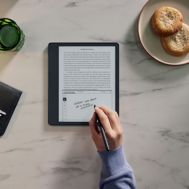 Someone writing on a Kindle Scribe.