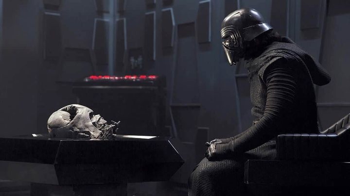 Kylo Ren sits and stares as Darth Vader's mask in The Force Awakens.