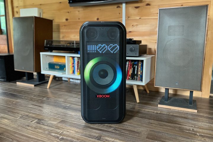 The LG XBoom XL7 portable party speaker next to a stereo system with big speakers.