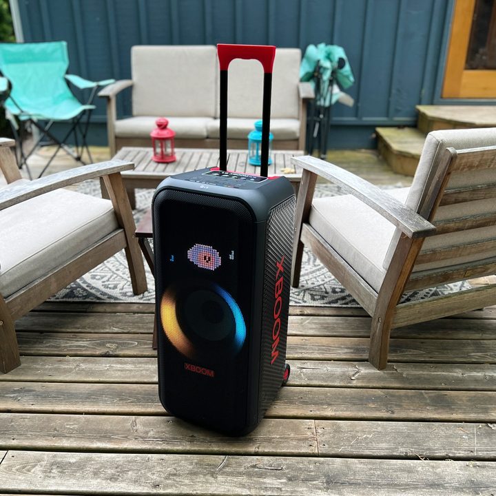 The LG XBoom XL7 portable party speaker with its handle extended on an outdoor deck.