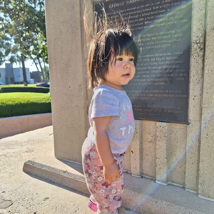 Toddler standing on park monument taken with a Samsung Galaxy A54