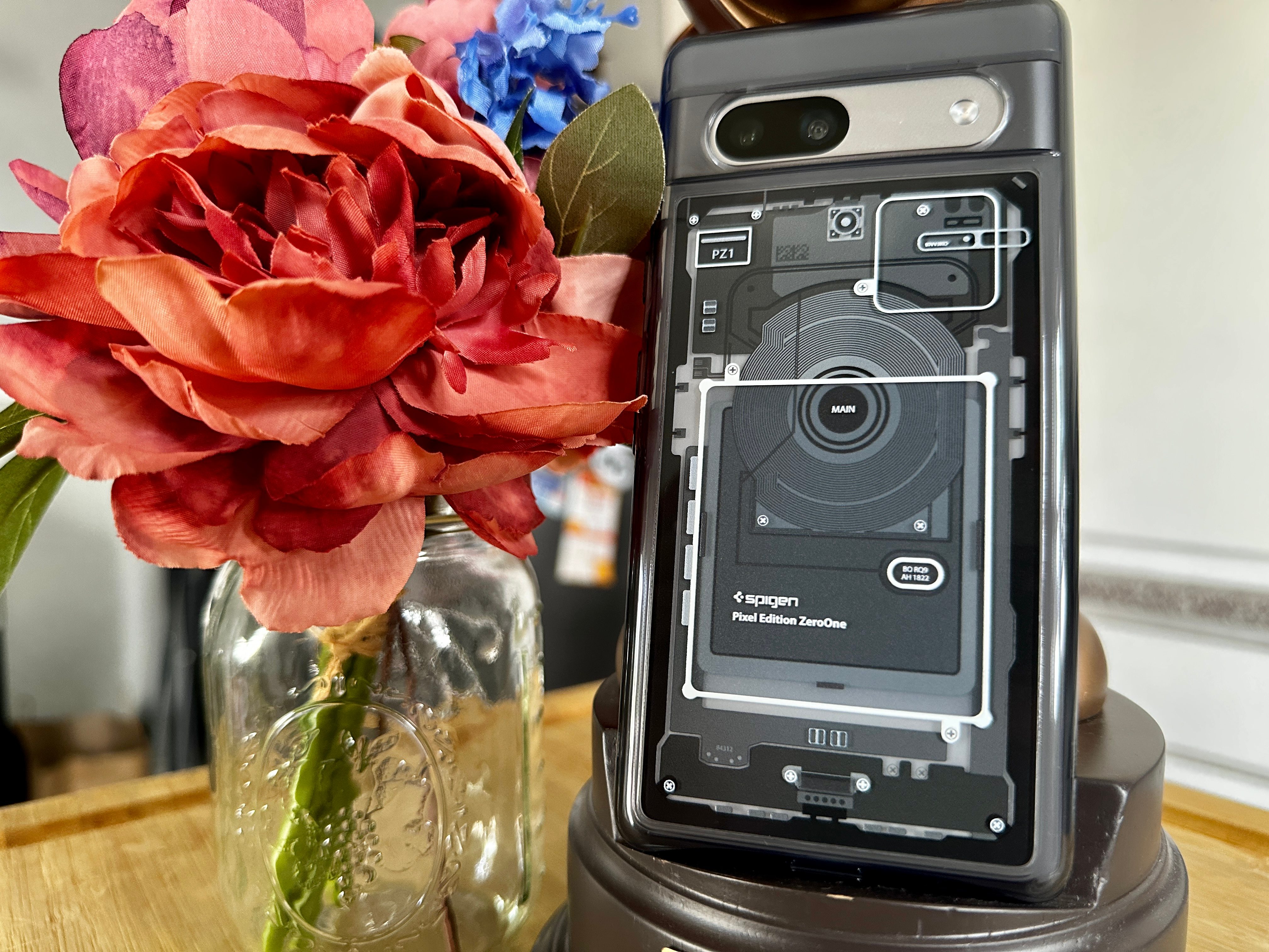 Spigen Ultra Hybrid Zero One Pixel 7a case close up on Mickey phone stand with flowers