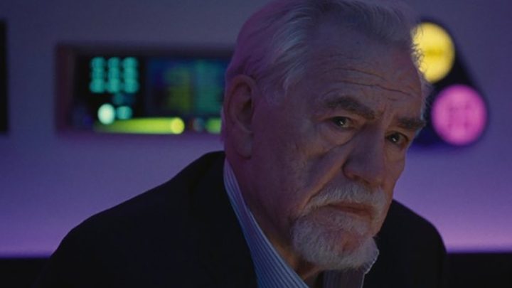 A close up of Logan Roy from Succession, sitting with the kids in a karaoke bar.