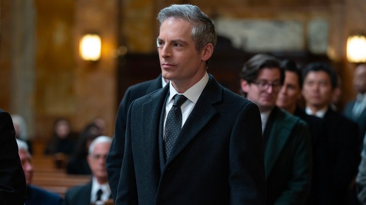 A man stands in church in Succession.
