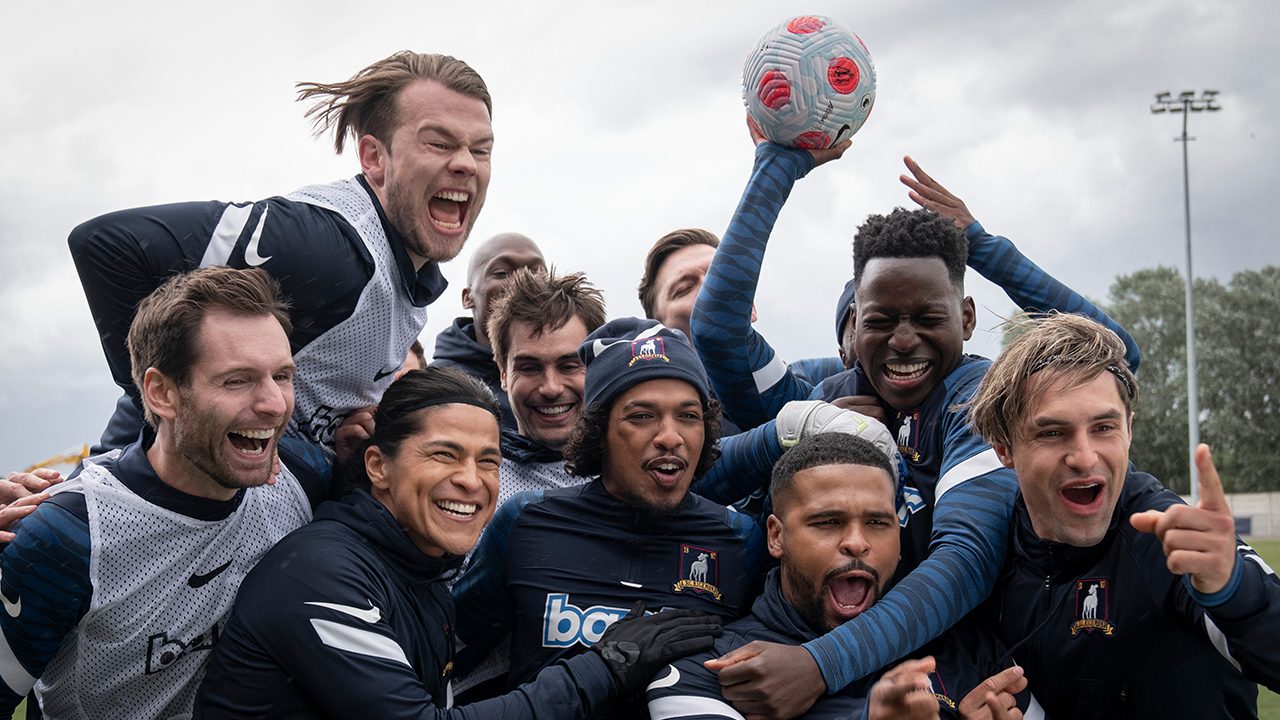 The AFC Richmond team cheering in a scene from Ted Lasso.