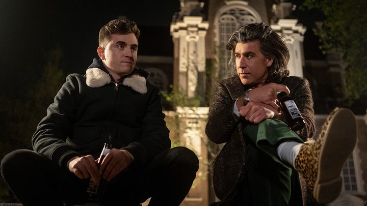 Colin and Trent sitting on steps together in Amsterdam in a scene from Ted Lasso.