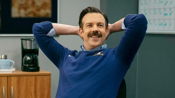Ted Lasso leans back in Ted Lasso season 3.