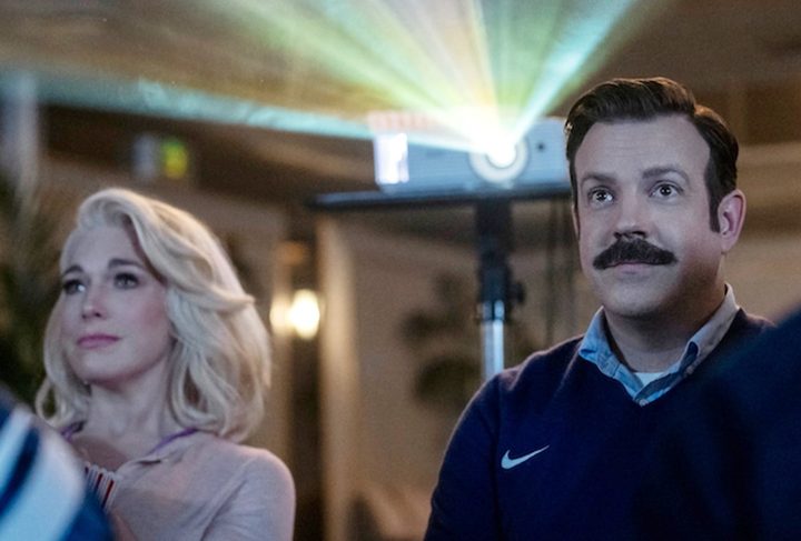 A man and a woman watch a movie in Ted Lasso season 3.