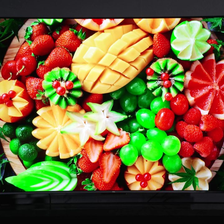 A vibrant fresh fruit platter shown on a TCL Q6.