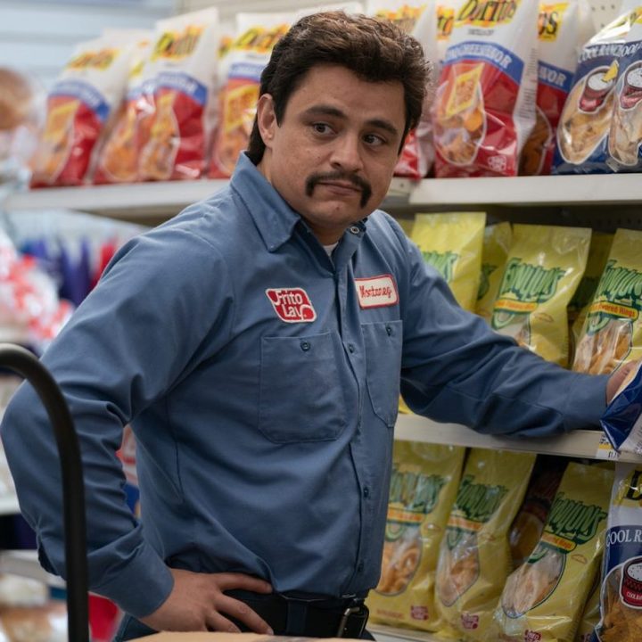 A worker stands against the shelves in Flamin' Hot.
