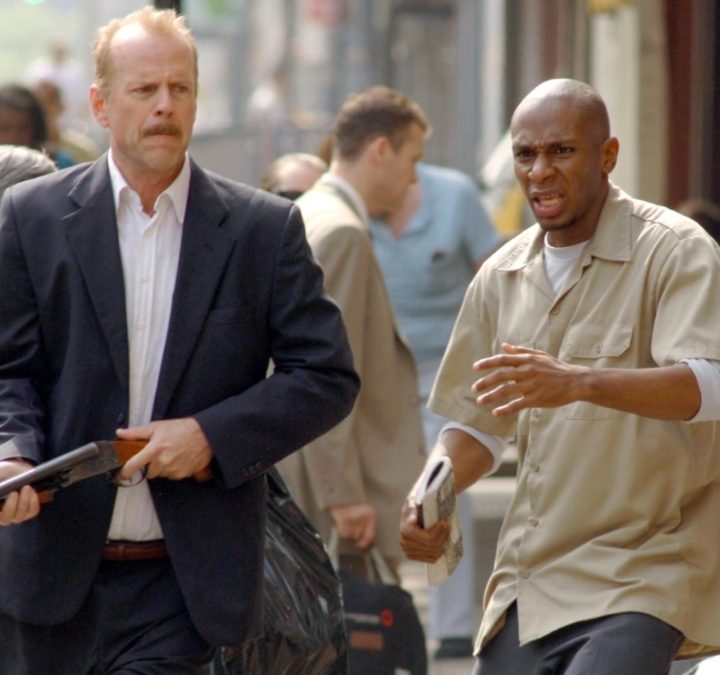 Bruce Willis holds a gun next to Mos Def in 16 Blocks.