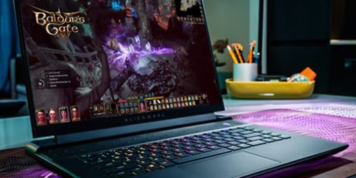 An Alienware m16 gaming laptop in use on a desk, playing Baldur's Gate III.