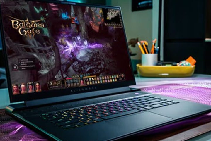 An Alienware m16 gaming laptop in use on a desk, playing Baldur's Gate III.