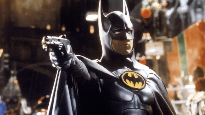 Batman aiming his gadget at a henchman in Batman Returns.