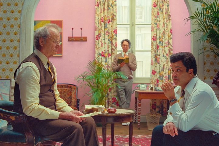 Bill Murray and Jeffrey Wright sit across from each other in The French Dispatch.