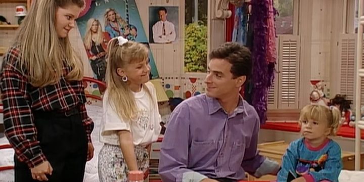 Danny Tanner talks to his three daughters in Full House.