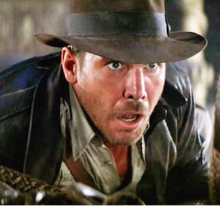 Harrison Ford is frightened by a snake in Raiders of the Lost Ark.