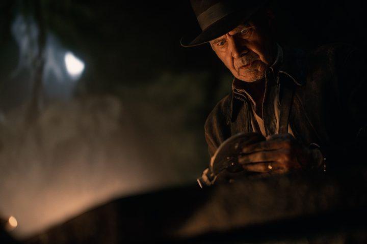 Harrison Ford holds a gold disk in Indiana Jones 5.