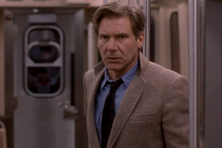 Harrison Ford stands on a train in The Fugitive.