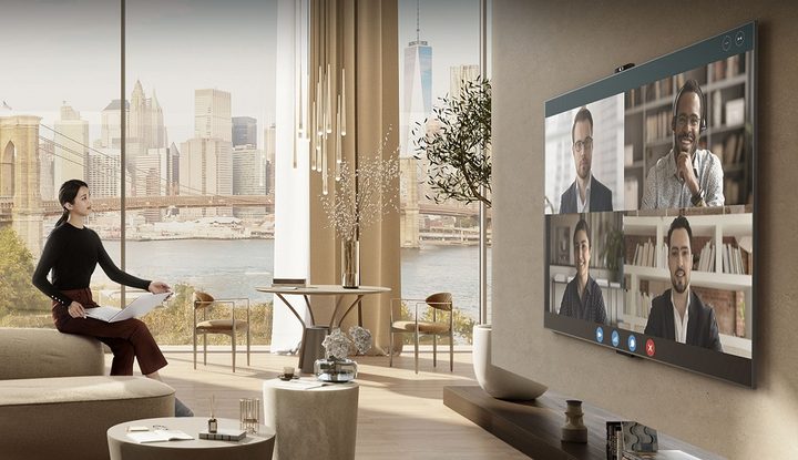 Woman in living room using LG's Smart Cam for a video call.