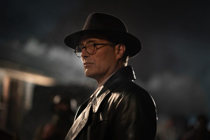 Mads Mikkelsen wears a leather trench coat in Indiana Jones and the Dial of Destiny.