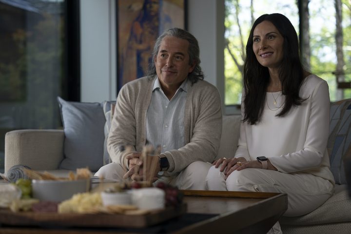Matthew Broderick and Laura Benanti sit on a couch together in No Hard Feelings.
