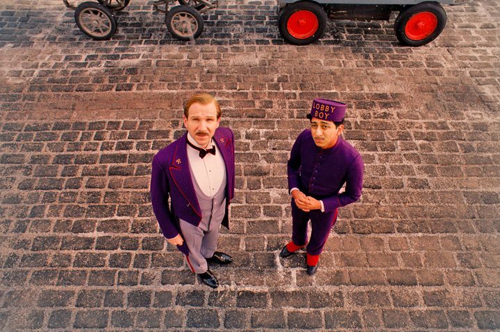 Ralph Fiennes and Tony Revolori look up in The Grand Budapest Hotel.