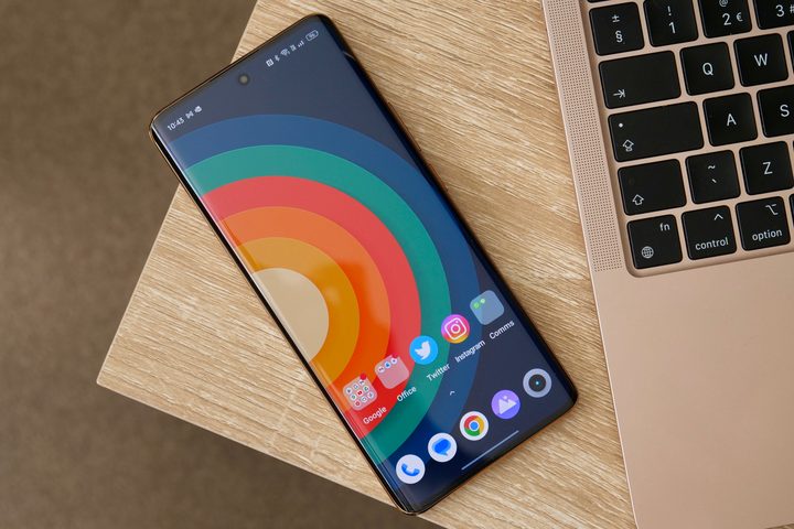 The Realme 11 Pro Plus's screen, placed next to a laptop.