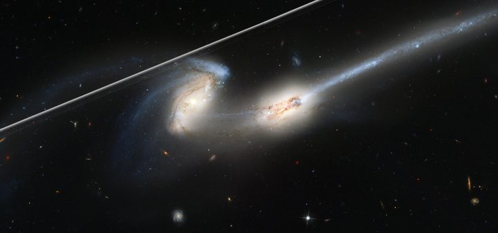 This image captures the streak of an Earth-orbiting artificial satellite crossing Hubble's field of view during an observation of "The Mice" interacting galaxies (NGC 4676). A typical satellite trail is very thin and will affect less than 0.5% of a single Hubble exposure. Though in this case the satellite overlaps a portion of the target galaxy, the observation quality is not affected. That's because multiple exposures are taken of the same target. And the satellite trail is not in other frames. Developers at the Space Telescope Science Institute in Baltimore, Maryland, have software that identifies the bad pixels from the satellite photobombing, the extent to which they affect the image, and then flags them. When flagged, scientists can recover the full field of view. Even as the number of satellites increases over the decade, these tools for cleaning the images will still be applicable.